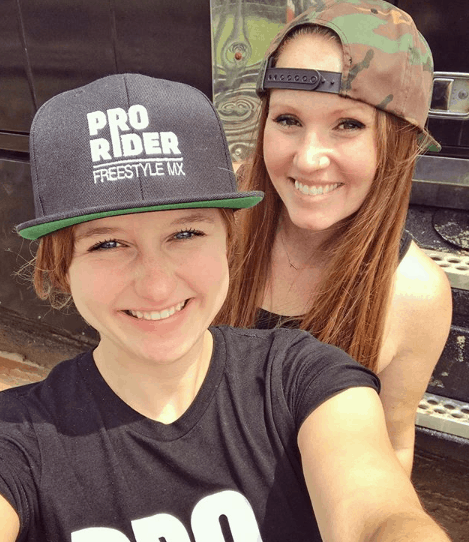 Two females wearing branded hats