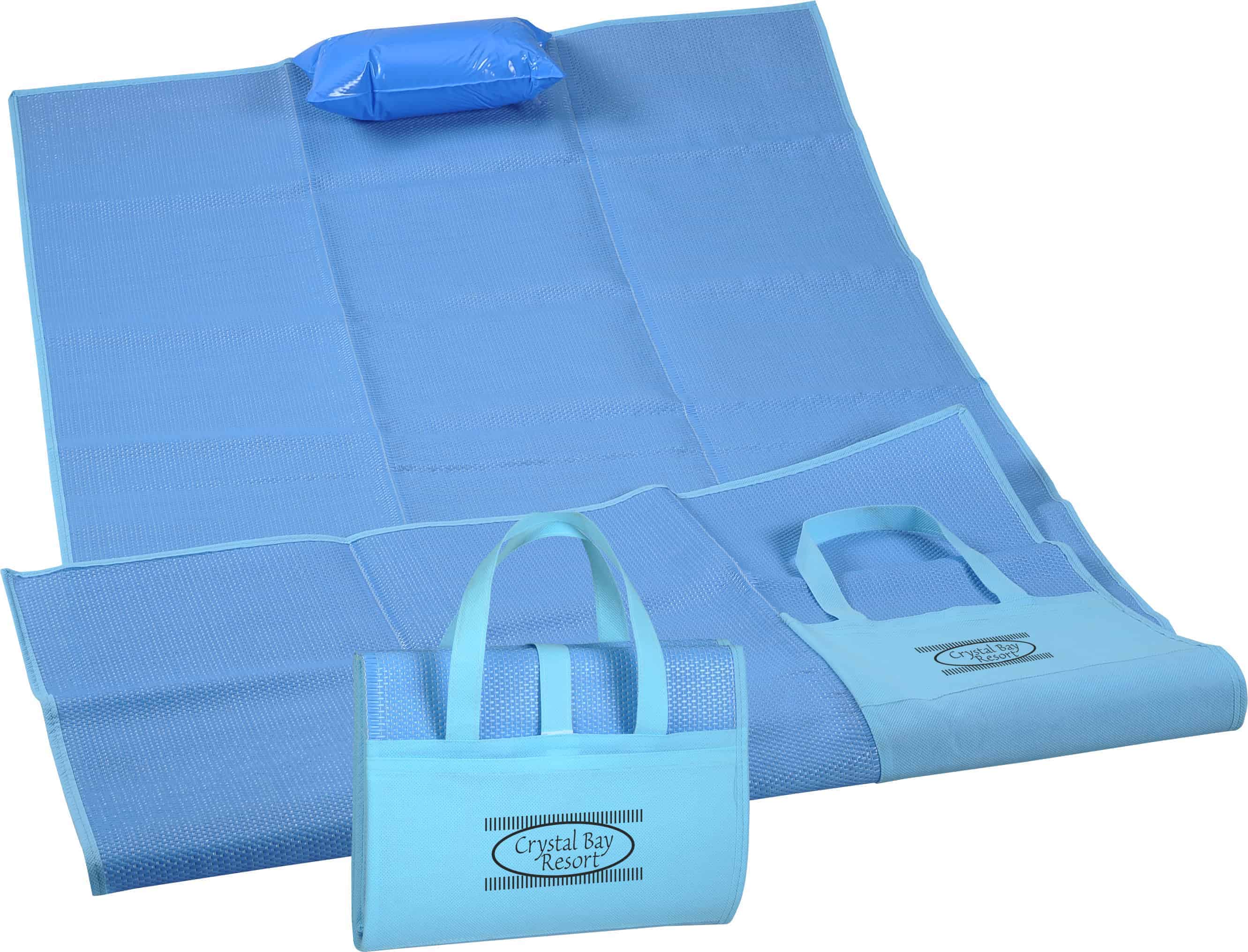 A blue Surf & Sand Beach Mat with inflatable pillow. 