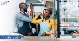 Two people share a high five for an article on showing employee appreciation.