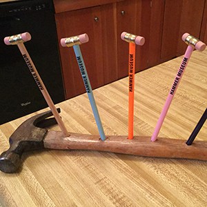 An array of Hammer Pencils standing in holes on a hammer. 