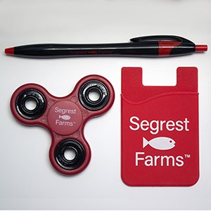 A red Adhesive Cell Phone Wallet with pen and red Trio Fidget Spinner.