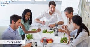 5 people sitting at a table eating a healthy meal - it is a 3 minute read to read the blog entitled - Best promotional giveaways for a healthy start to the year