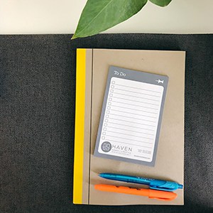 To-do notepad with one blue and one orange pen