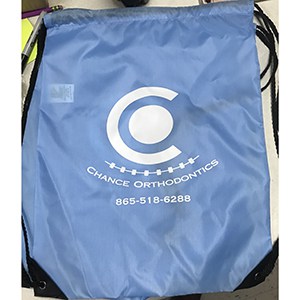 Empty blue drawstring bag branded to Chance Orthodontics