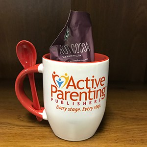 Mug with built-in spoon in handle and a hot cocoa pack inside