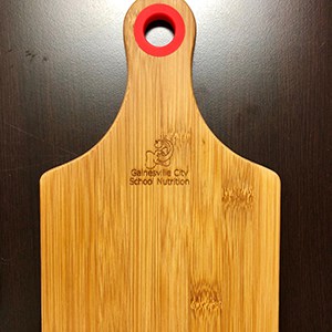 Wooden cutting board with red handle hole