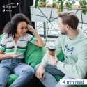 Two smiling friends sitting on green bean bags.