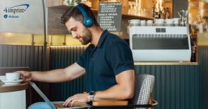 Man working at a laptop in a coffee shop.