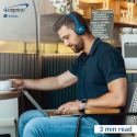 Man working at a laptop in a coffee shop.