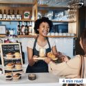 Barista serving coffee and croissant to customer.