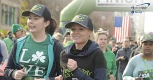 Women wearing branded caps running in a race.