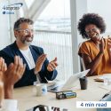 Two co-workers clapping in a meeting