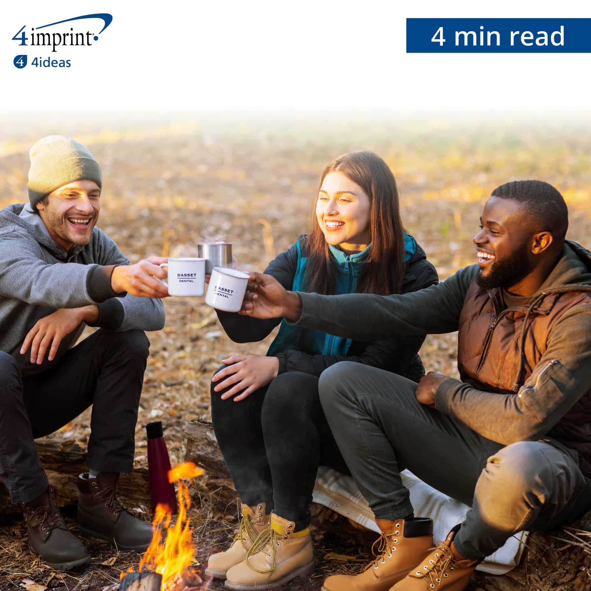 Three people sitting around a campfire clinking their coffee mugs together.