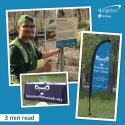 Photo compilation of male volunteer standing by informational sign, a table with a branded cover and a sail sign.