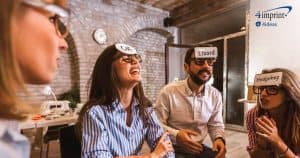 People in an office playing a charades game with words on their foreheads.