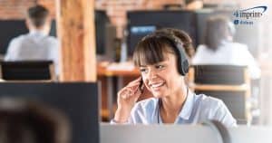 Woman wearing headset working in call center.