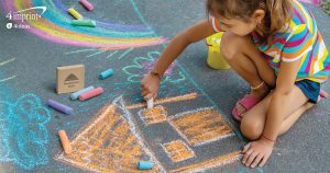 Child coloring with sidewalk chalk.