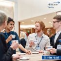 People interacting during a coffee break at a business event.