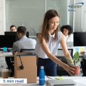 New employee placing a plant on her desk.