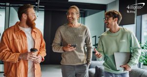 Three team members walking in an office setting.