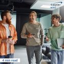 Three team members walking in an office setting.