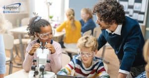 Teacher and students wearing safety goggles in a science lab setting.