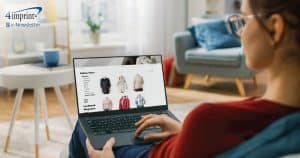 Woman in living room looking at ecommerce laptop screen with clothes.