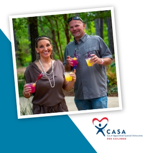 Two smiling people holding colorful, festive drinks.