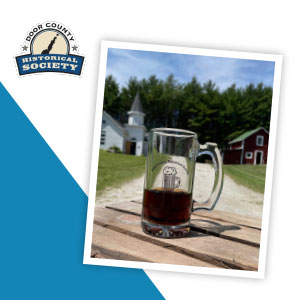 A logoed mug on a picnic table.