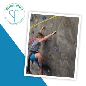 Child on a rock-climbing wall.