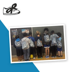 Group of students wearing branded sportpacks on their backs.