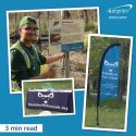 Photo compilation of a banner, logo table cover and volunteer standing by a park beaver sign. 3 minute read.