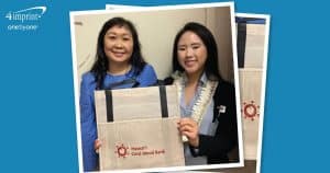 Two Hawai’i Cord Blood Bank staff displaying a branded reusable grocery bag. 
