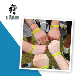 A circle of arms with branded awareness bracelets on the wrists.