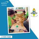 Photo children playing a block-stacking game.