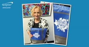 Woman holding a blue bag with a logo.