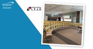 Rows of auditorium seats containing branded drawstring bags.