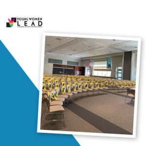 Rows of auditorium seats containing branded drawstring bags.