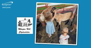 Children in a farm setting with a goat and a pony.