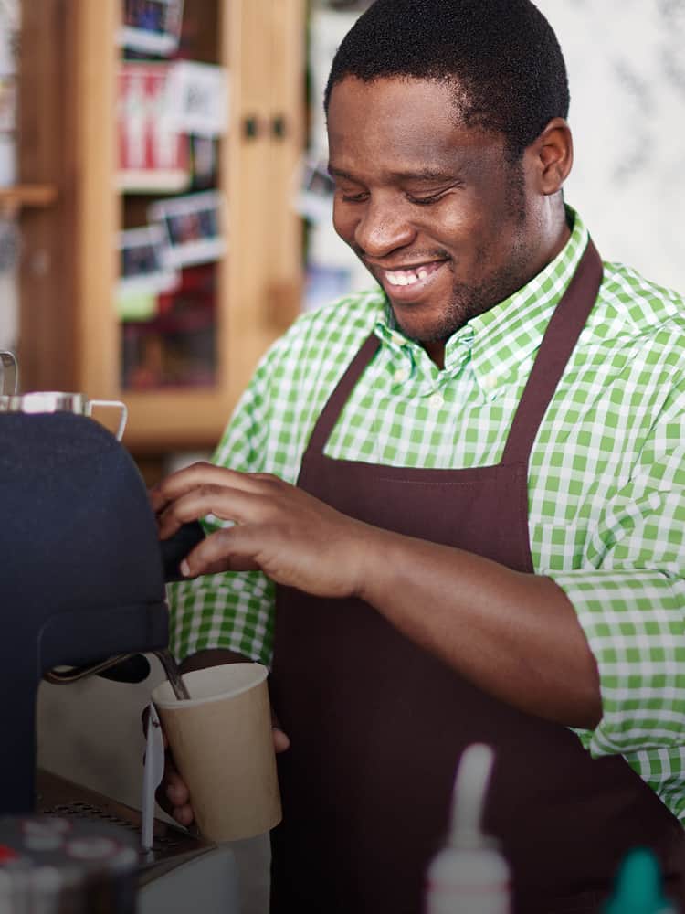 A man pours a cup of coffee.