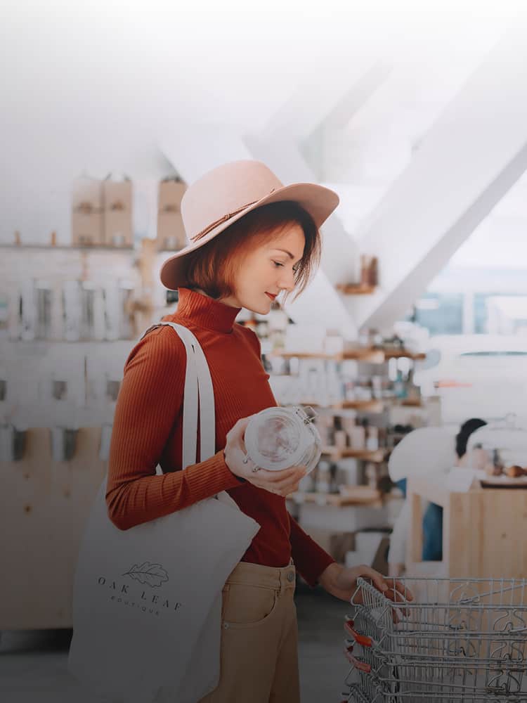 Woman in hat with tote bag shopping