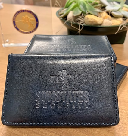Leather business card hold with Sunstates Security logo debossed on it.