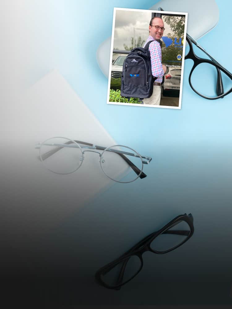 Man wearing backpack smiling at camera overlaid on image of glasses.