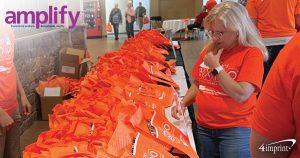 Photo from cover of amplify magazine of woman looking at event bags