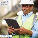 Construction worker looks at clipboard - 2 minute read