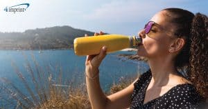 A woman drinks from a water bottle