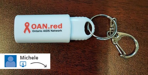 A white USB drive with a logo.