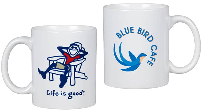 A white coffee mug with a Life is Good Adirondack logo on one side.