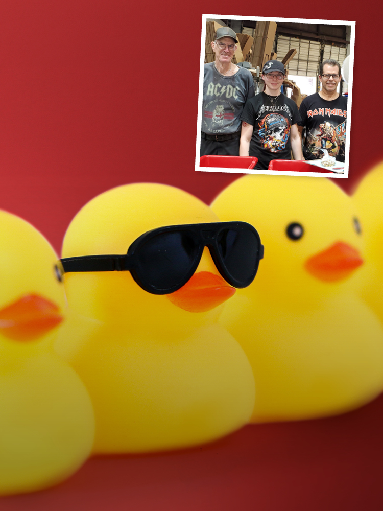 Rubber ducks in background with photo of team in rock 'n' roll t-shirts in top corner