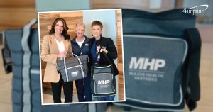 3 Major Health Partners employees holding 2 branded coolers - business care packages